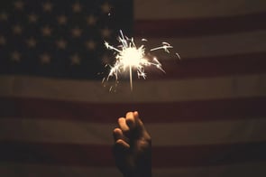 Sparkler in front of an American flag
