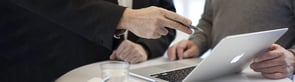 Man holding pen during sales meeting