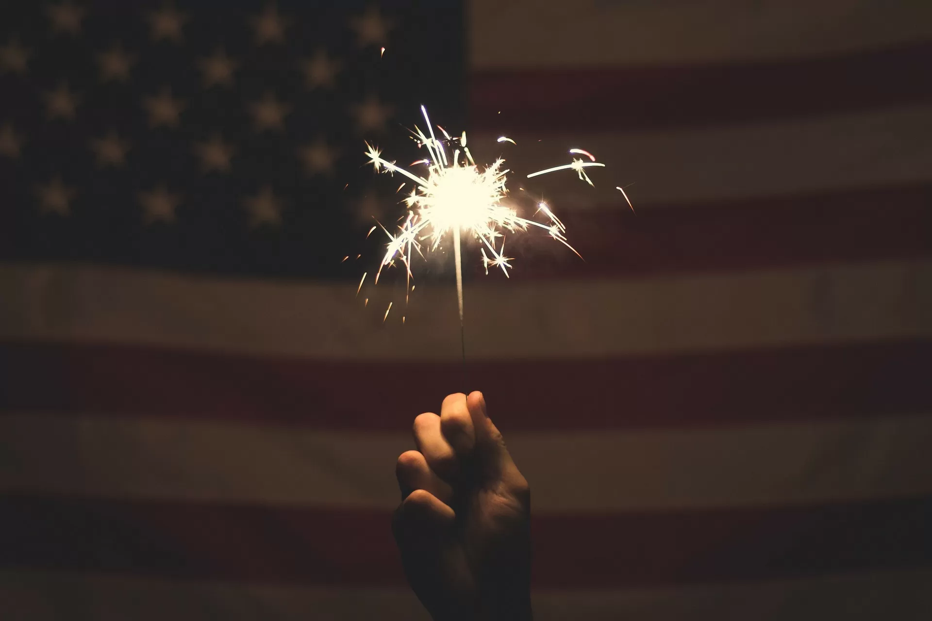 Sparkler in front of an American flag