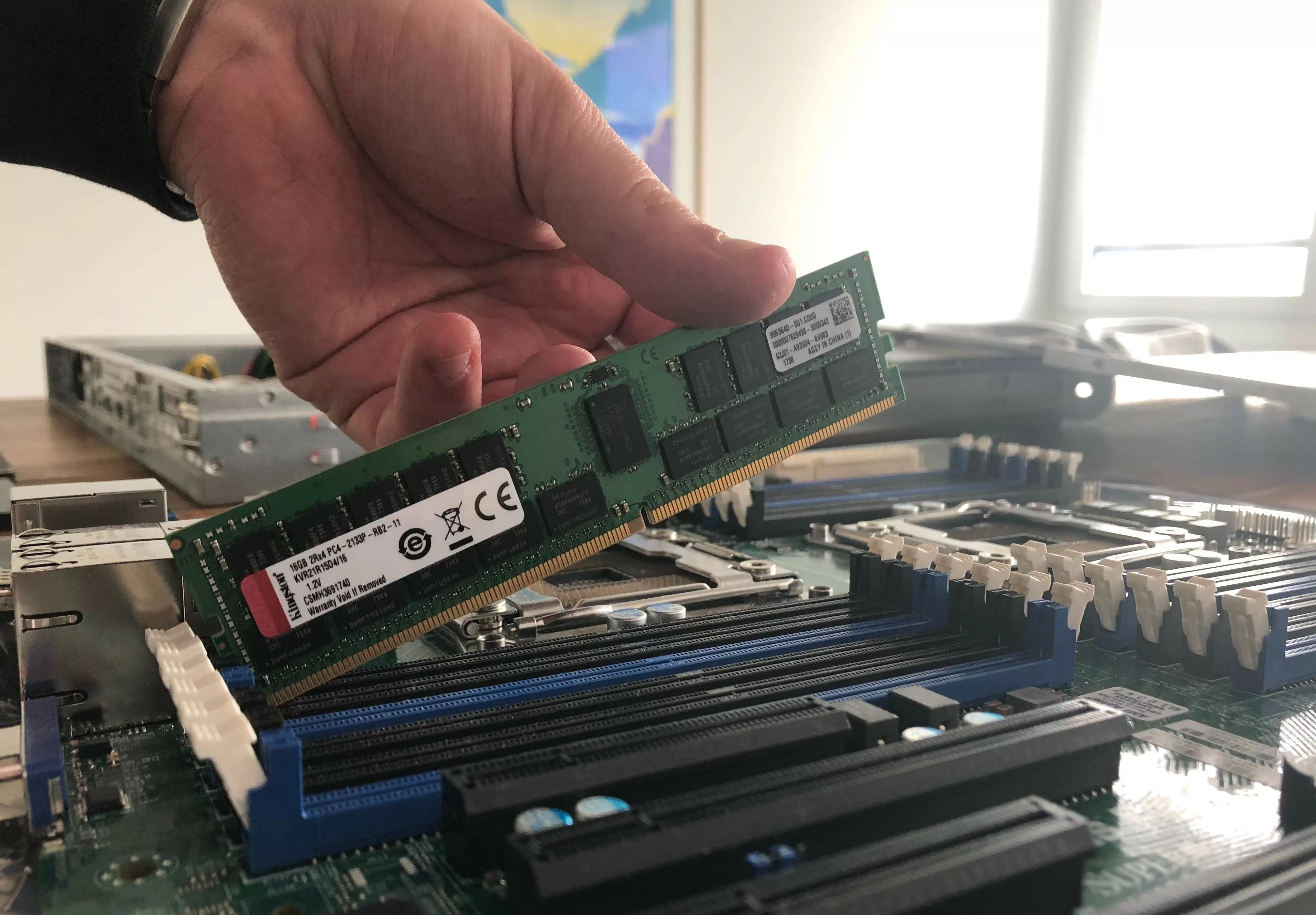 A man holds hardware to the camera